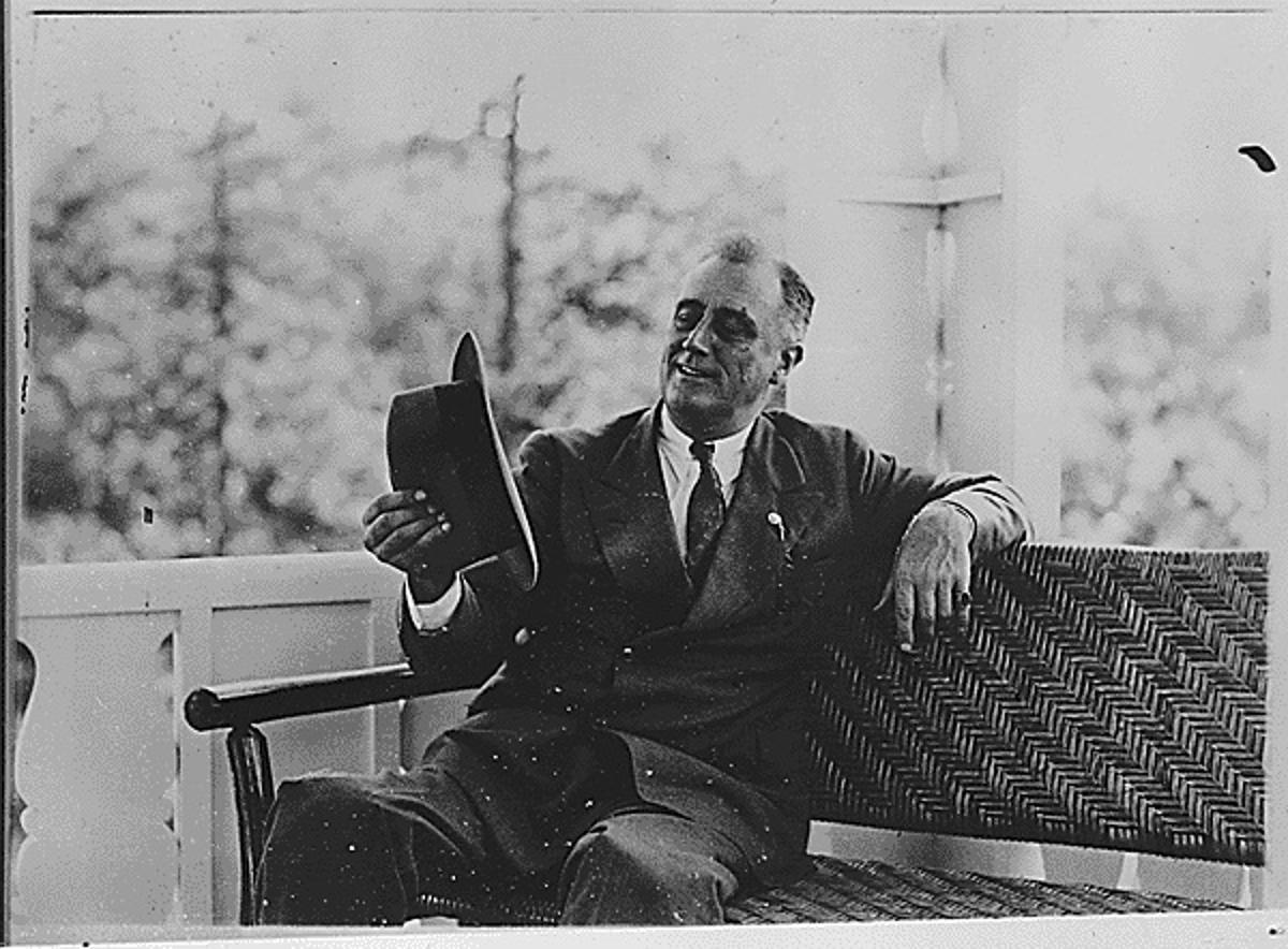 Franklin D. Roosevelt before he was president of the United States on a porch bench