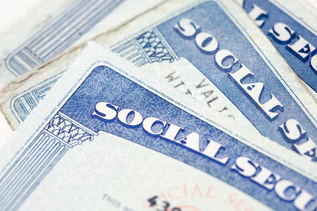 Close up photograph of three US Social Security cards