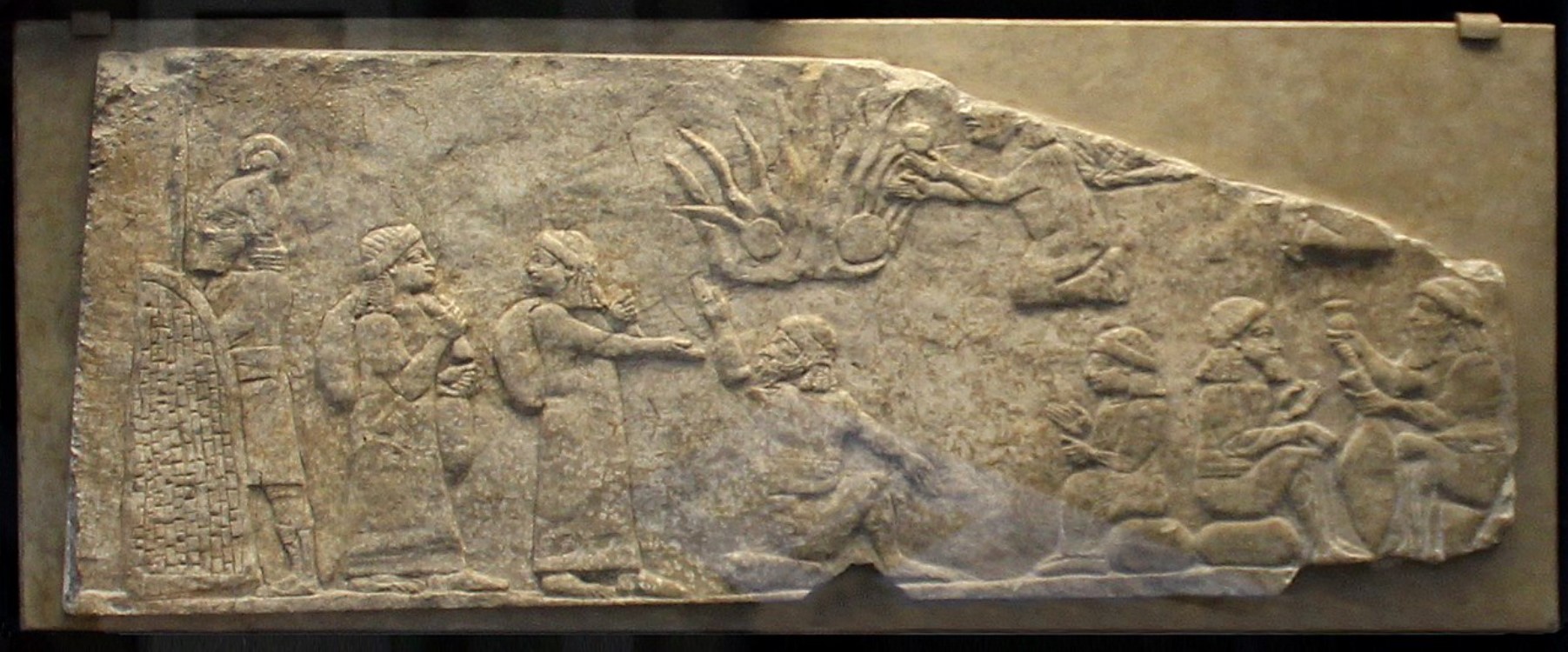 An image that depicts several Assyrian guards looking after numerous prisoners