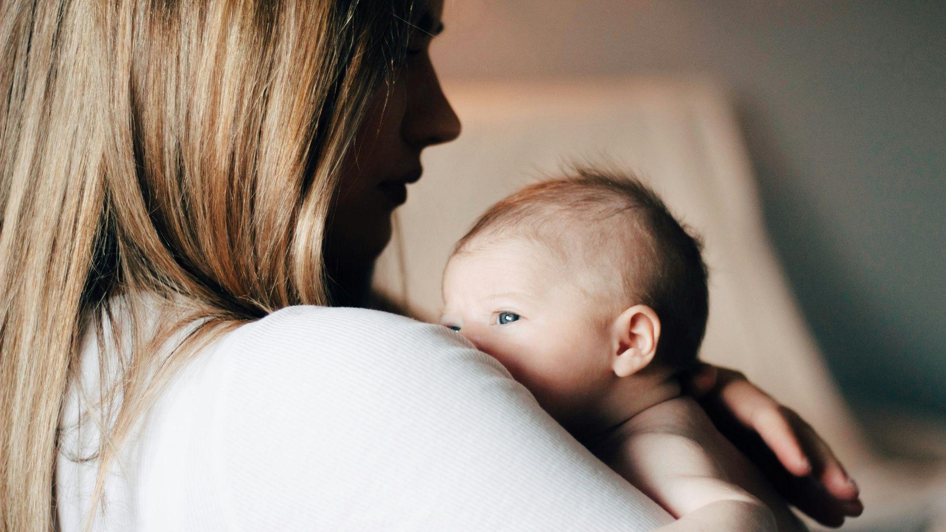 A mother holding a baby.