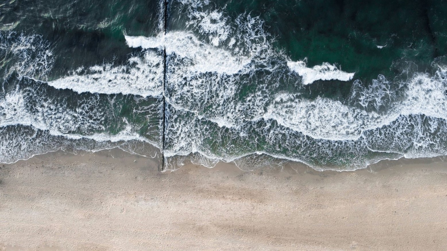 An aerial view of a beach and the Baltic Sea.
