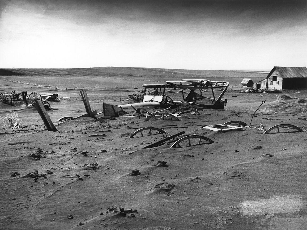 Buried machinery in a barn lot during the Dust Bowl in South Dakota, May 1936