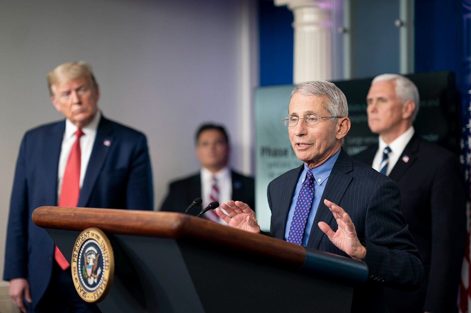 An image of Anthony Fauci during a speech alongside Donald Trump