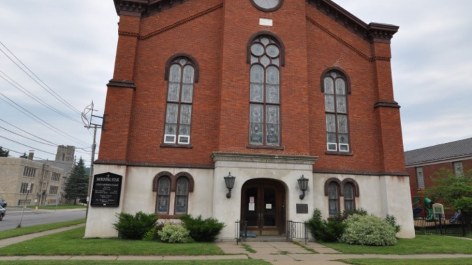 A historic church next to other buildings seen in Ilion, New York.