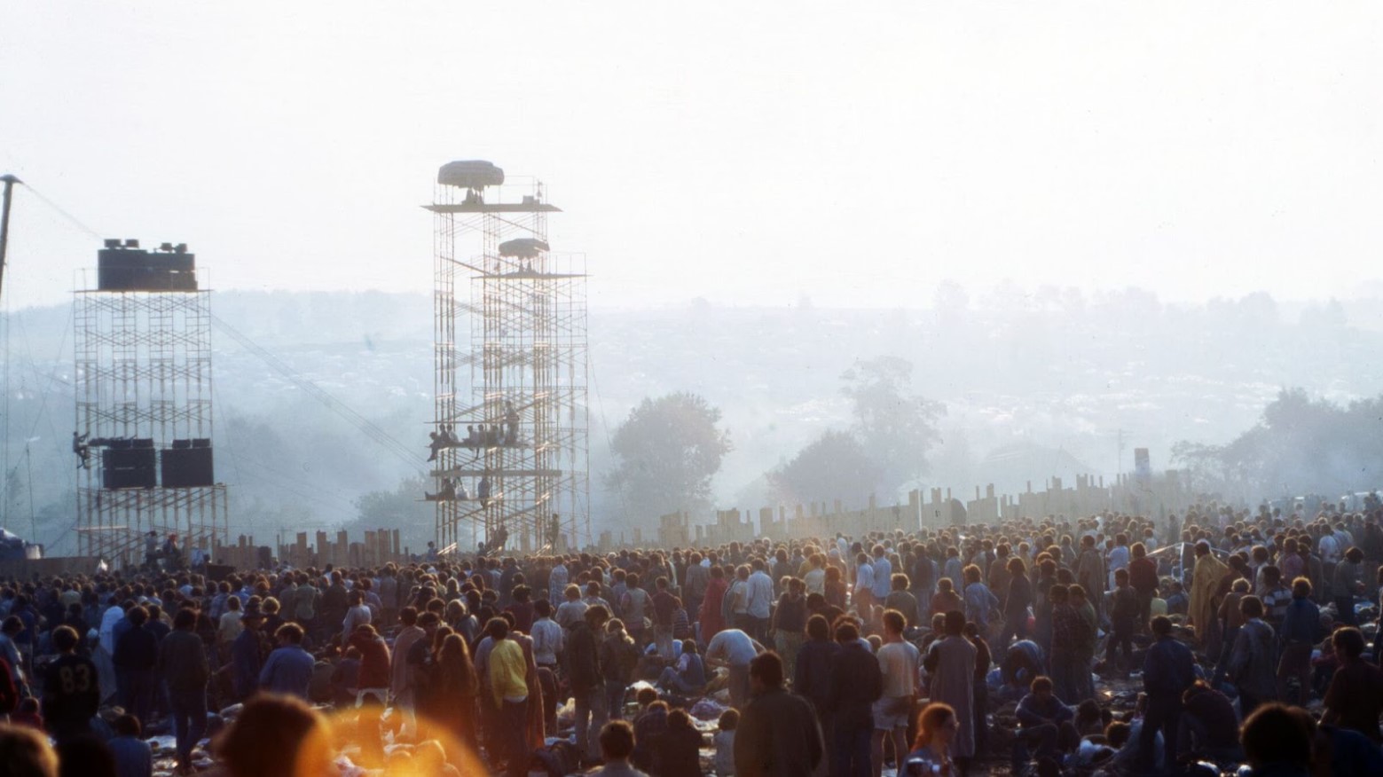 A huge crowd at Woodstock in 1969 during sunrise.