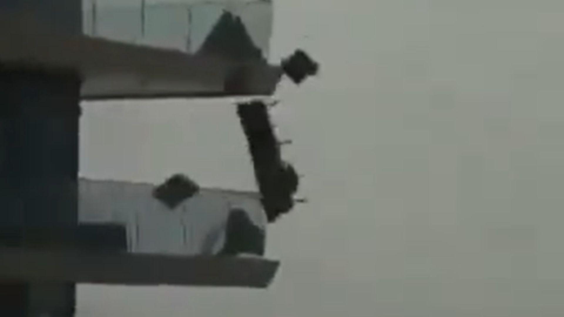 A zoomed-in image from the storm in Dubai. It shows a sofa, cushions, and chair set being flown off a balcony due to the strong winds.