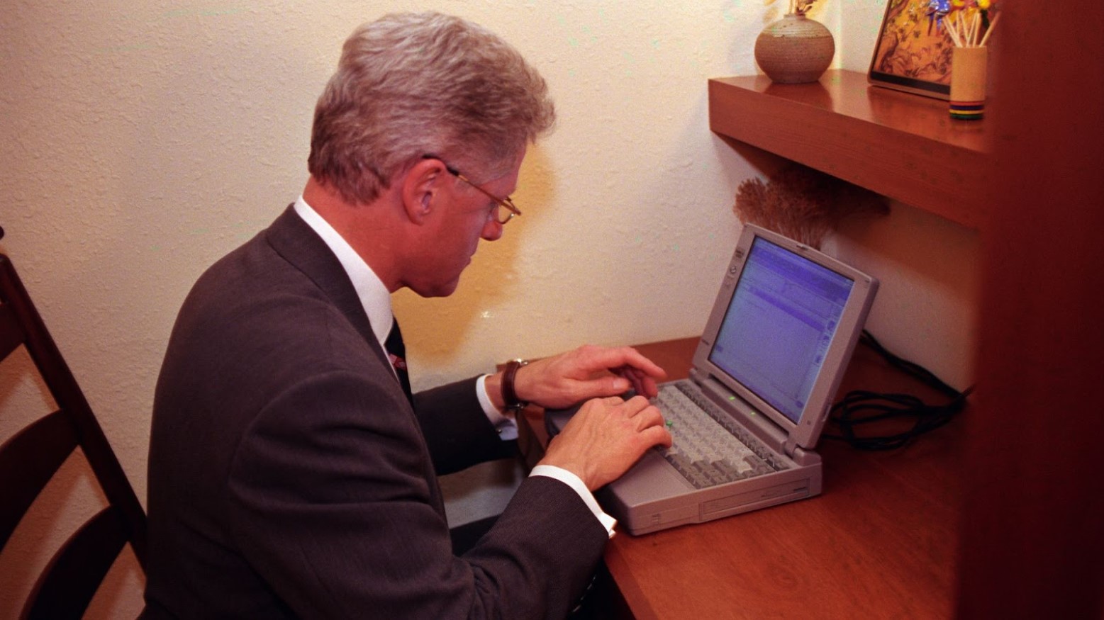 President Bill Clinton typing on a laptop in 1998.
