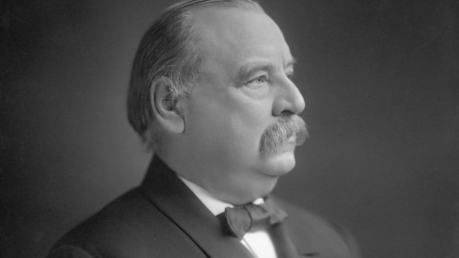 A 1903 black and white photo of Grover Cleveland.