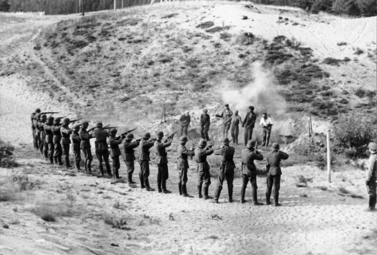 Several German soldiers execute prisoners by firing squad during WWII