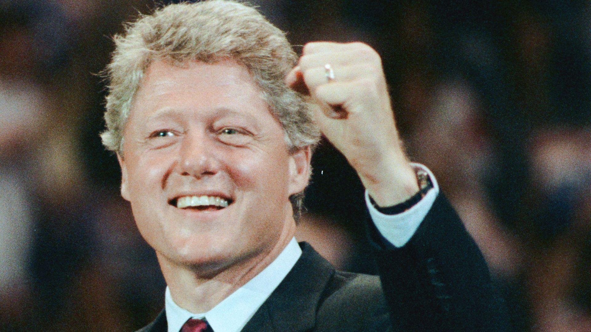 Bill Clinton smiling and raising his fist in 1992.