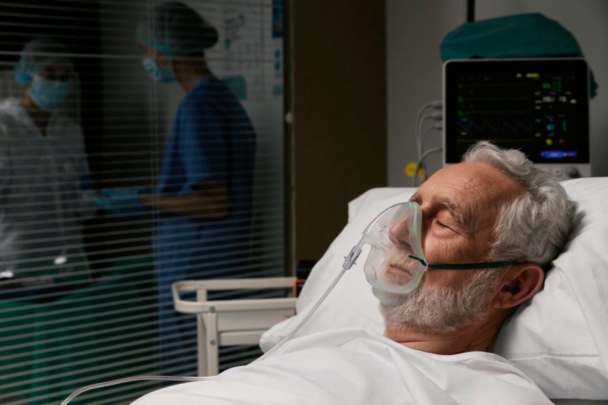 An image of an older man lying in a hospital bed