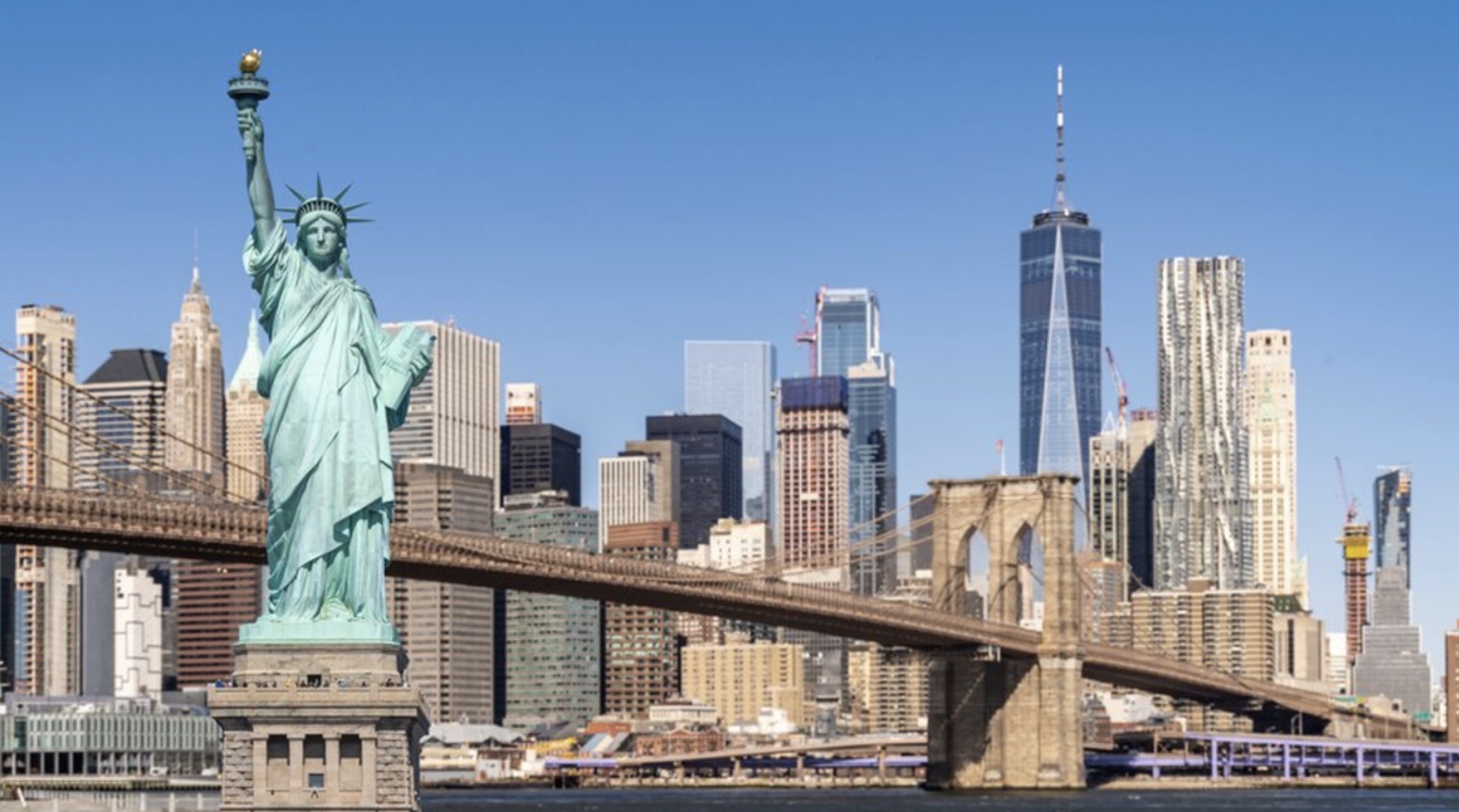 View of the skyline of New York City behind the Statue of Liberty
