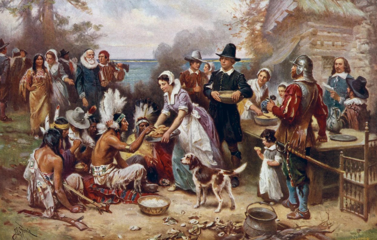 Oil painting of the colonists sharing the first Thanksgiving meal with Native Americans