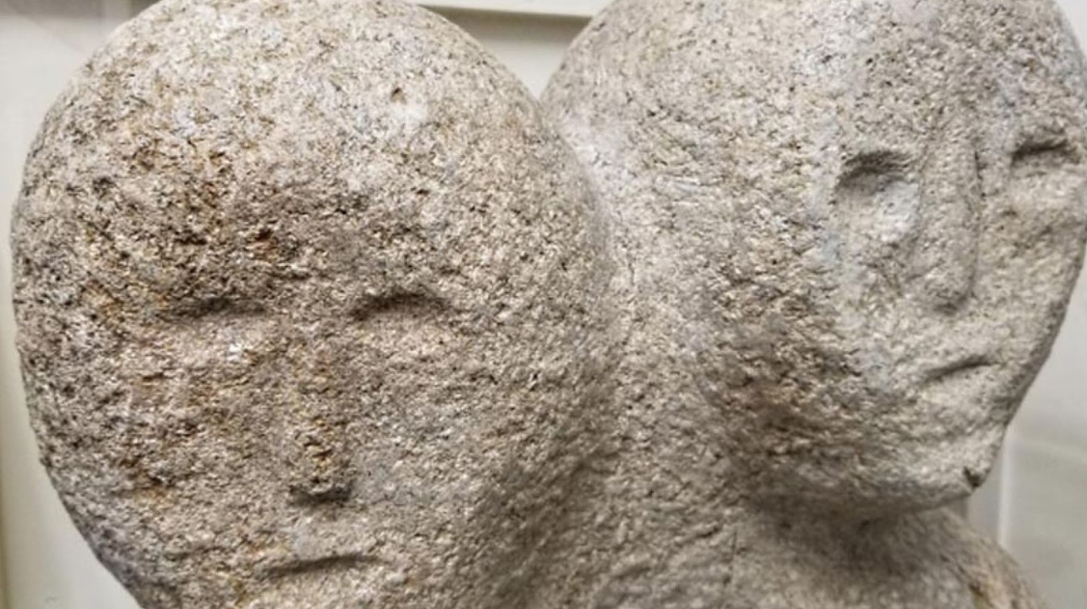 The faces of the moon-eyed people are made of stone. They have hollow eyes, mouths, and noses.
