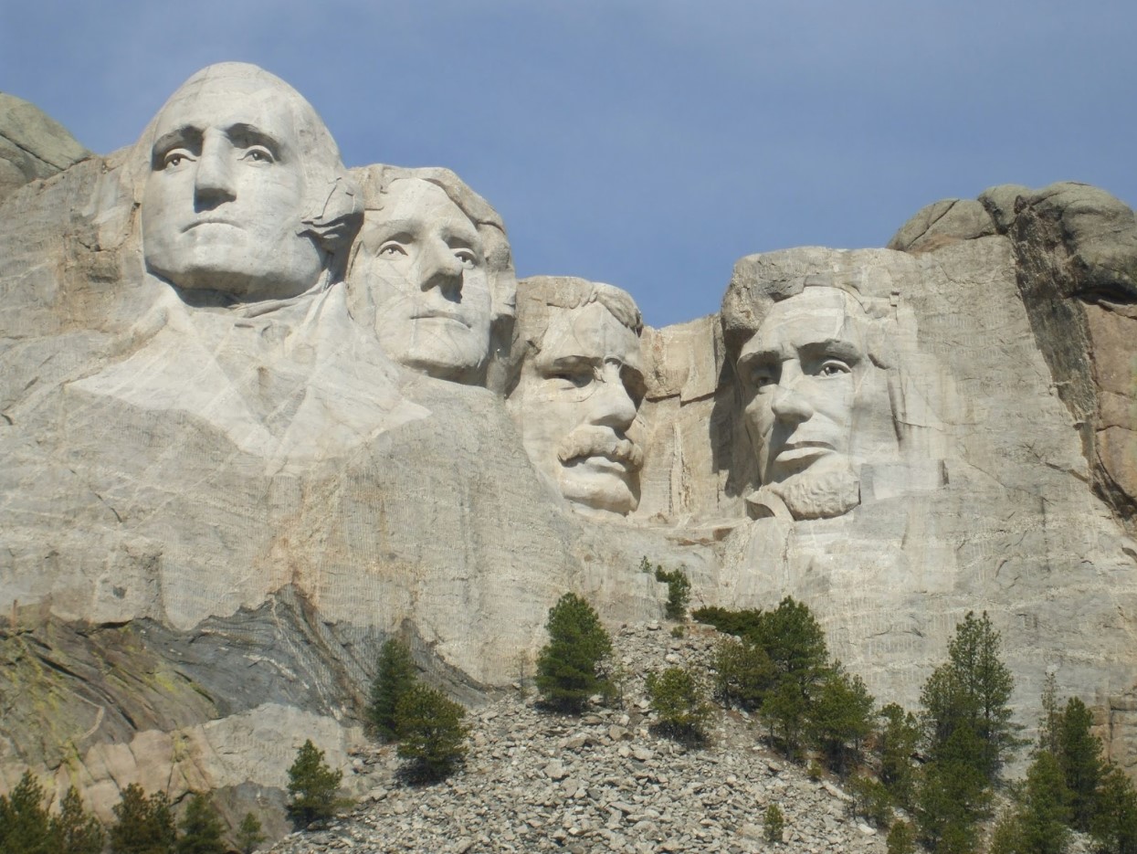 Faces of the Founding Fathers carved in stone on the side of a mountain at Mt. Rushmore