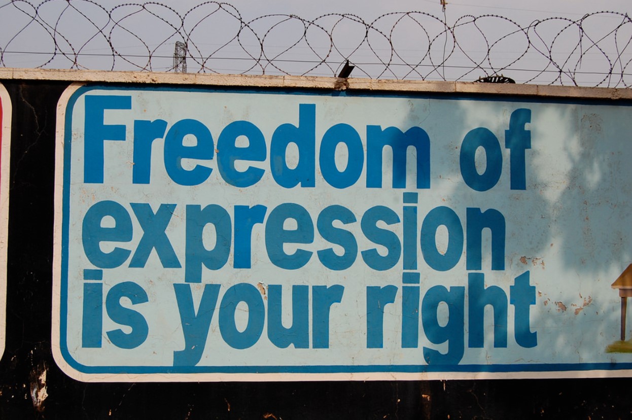 A large sign along a wall reads “Freedom of expression is your right”
