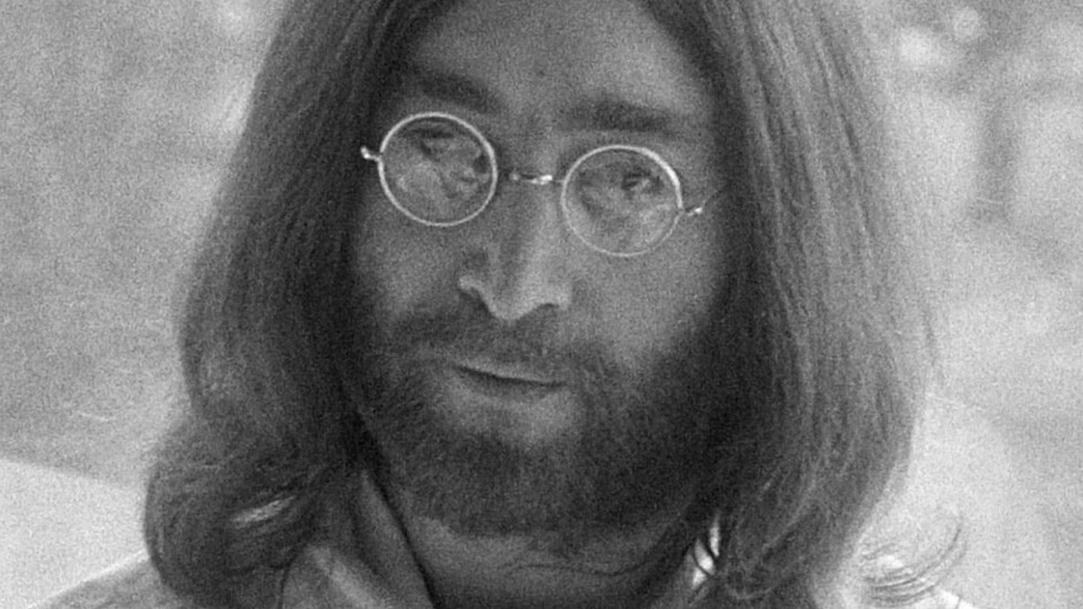 A black and white photo of John Lennon in 1969.