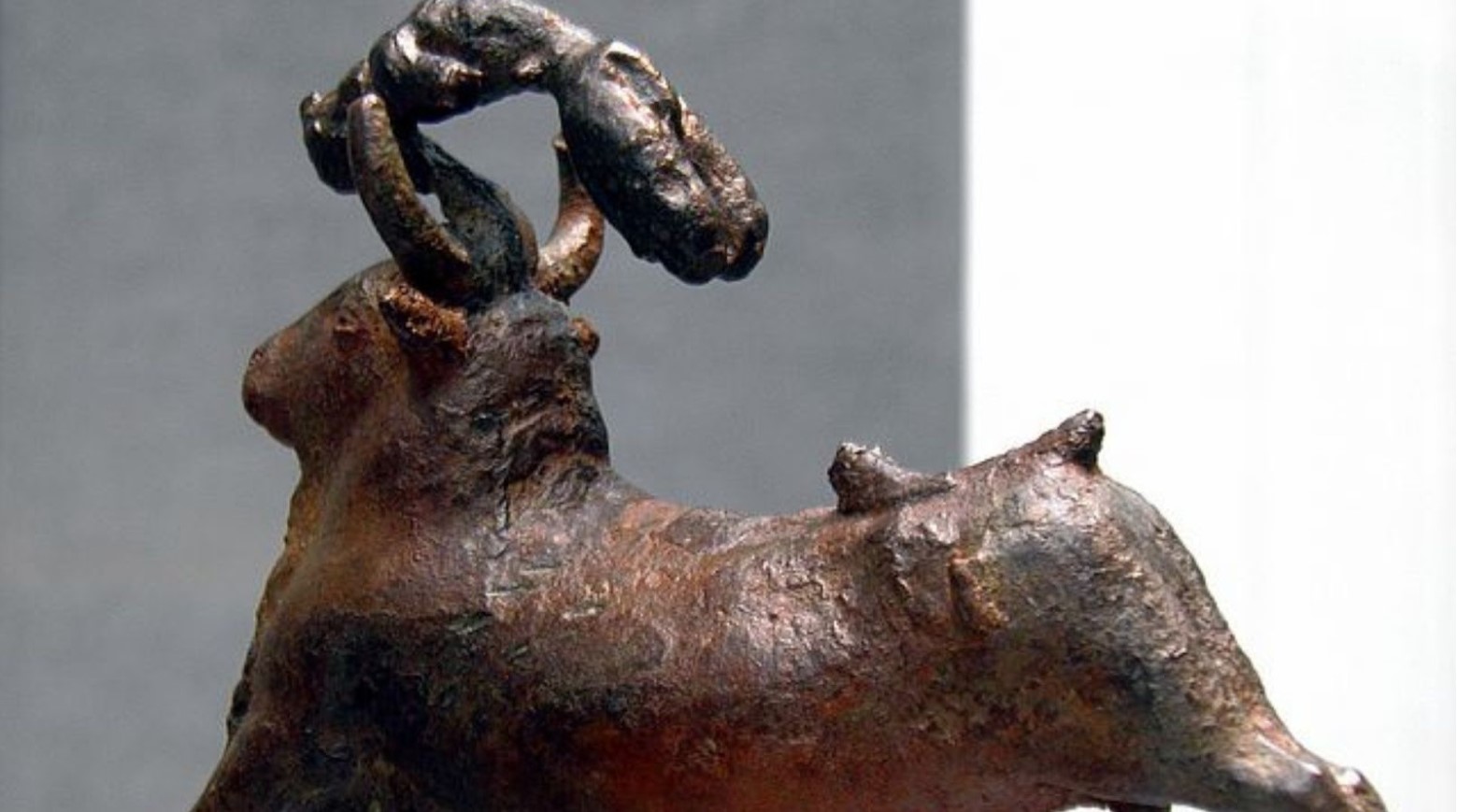 A Minoan bronze statue of a bull with a person jumping over him.