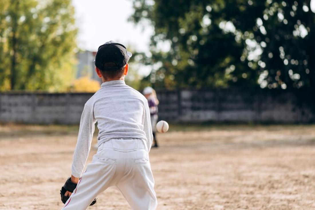 A young kid is pictured playing baseball