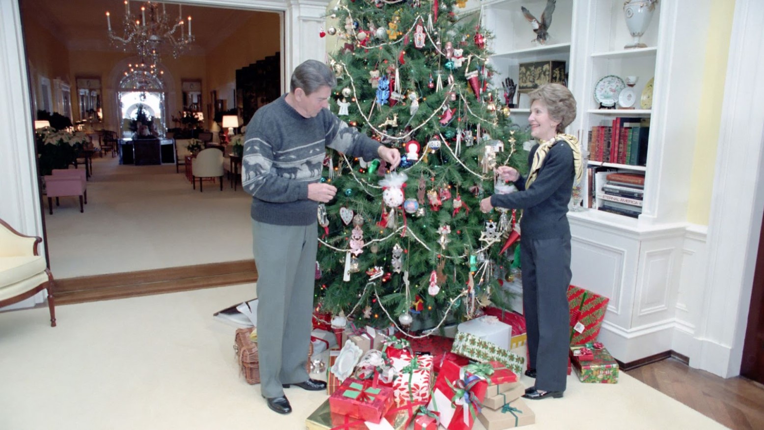 President Ronald Reagan and his wife decorating a Christmas tree in the White House in 1983.