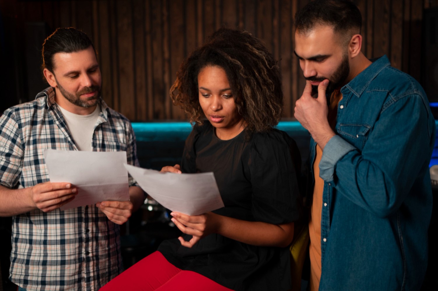An image of three Americans reading over a scientific pamphlet