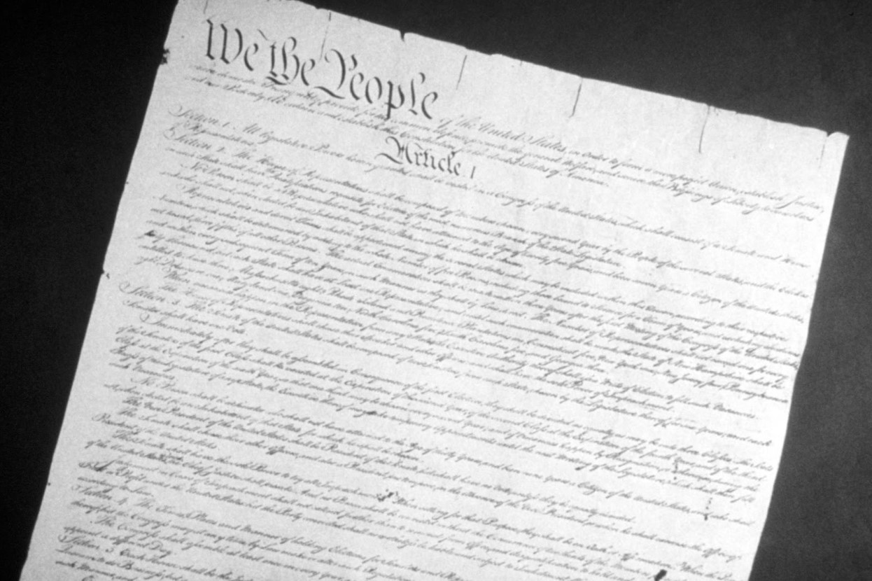A black and white photo of the United States Constitution