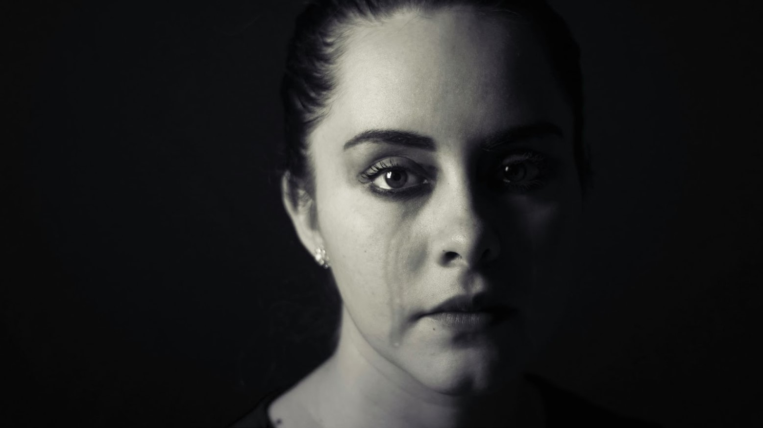 A woman with a tear-stained face.