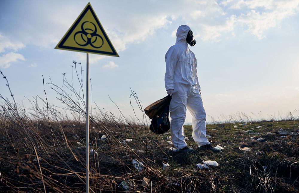 A picture of a man in a white hazard suit