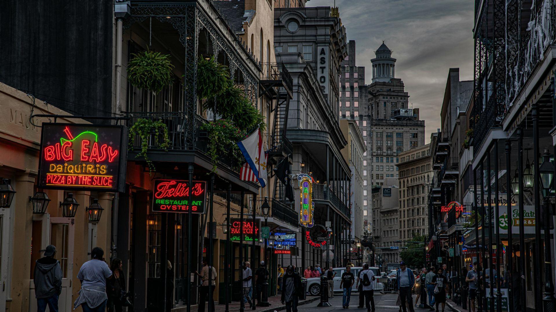 Many people walking down a street in New Orleans.