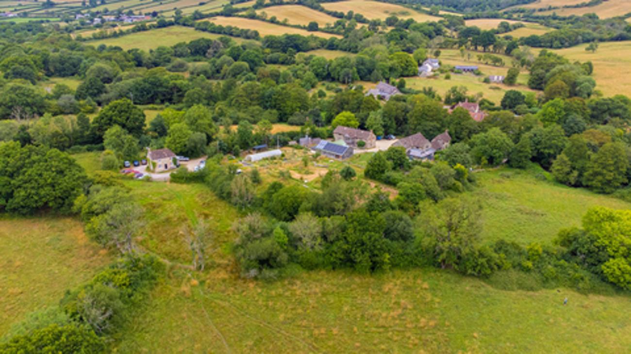 Aerial view of homes among green fields in Dorset, England