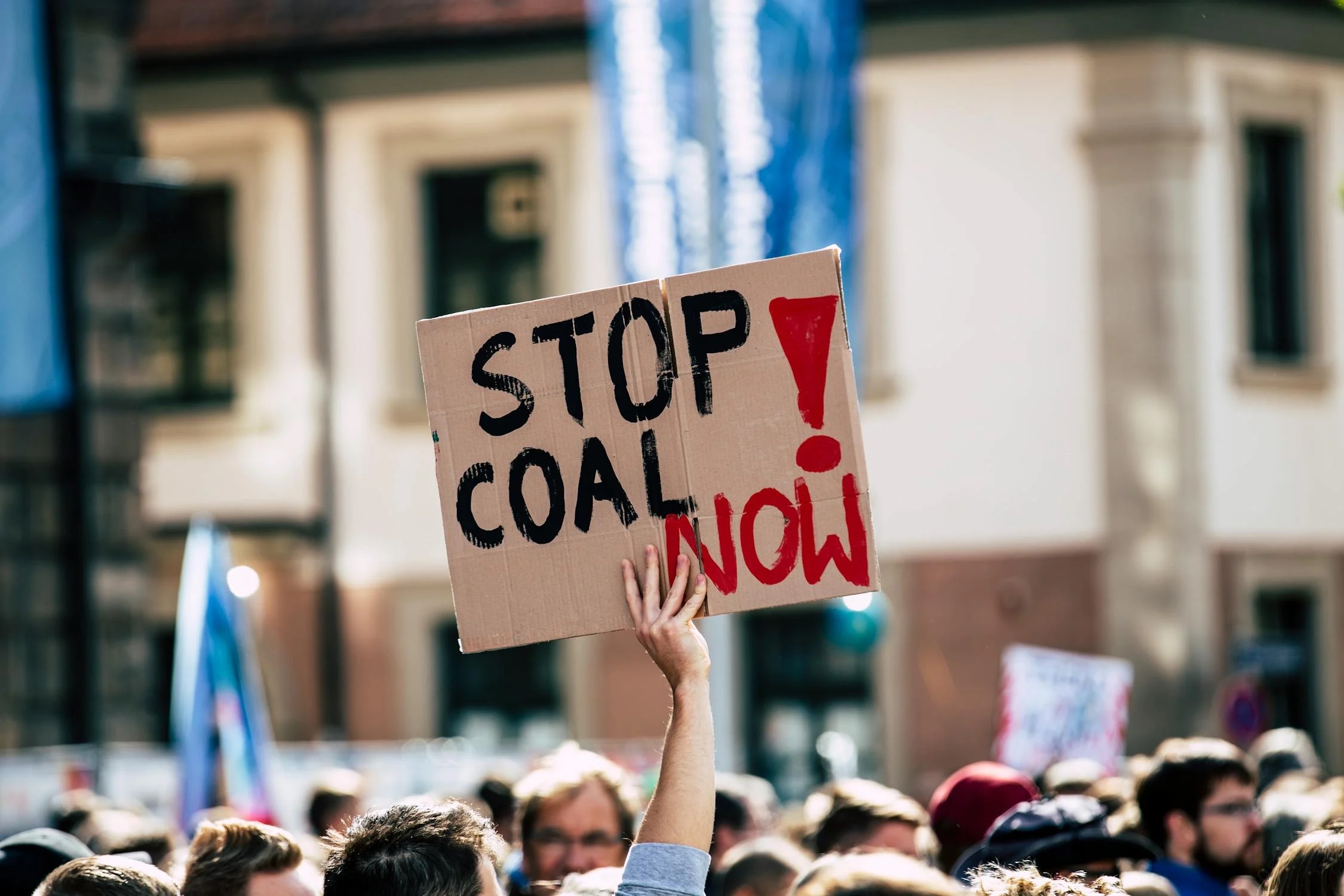 Climate protestors holding a cardboard sign