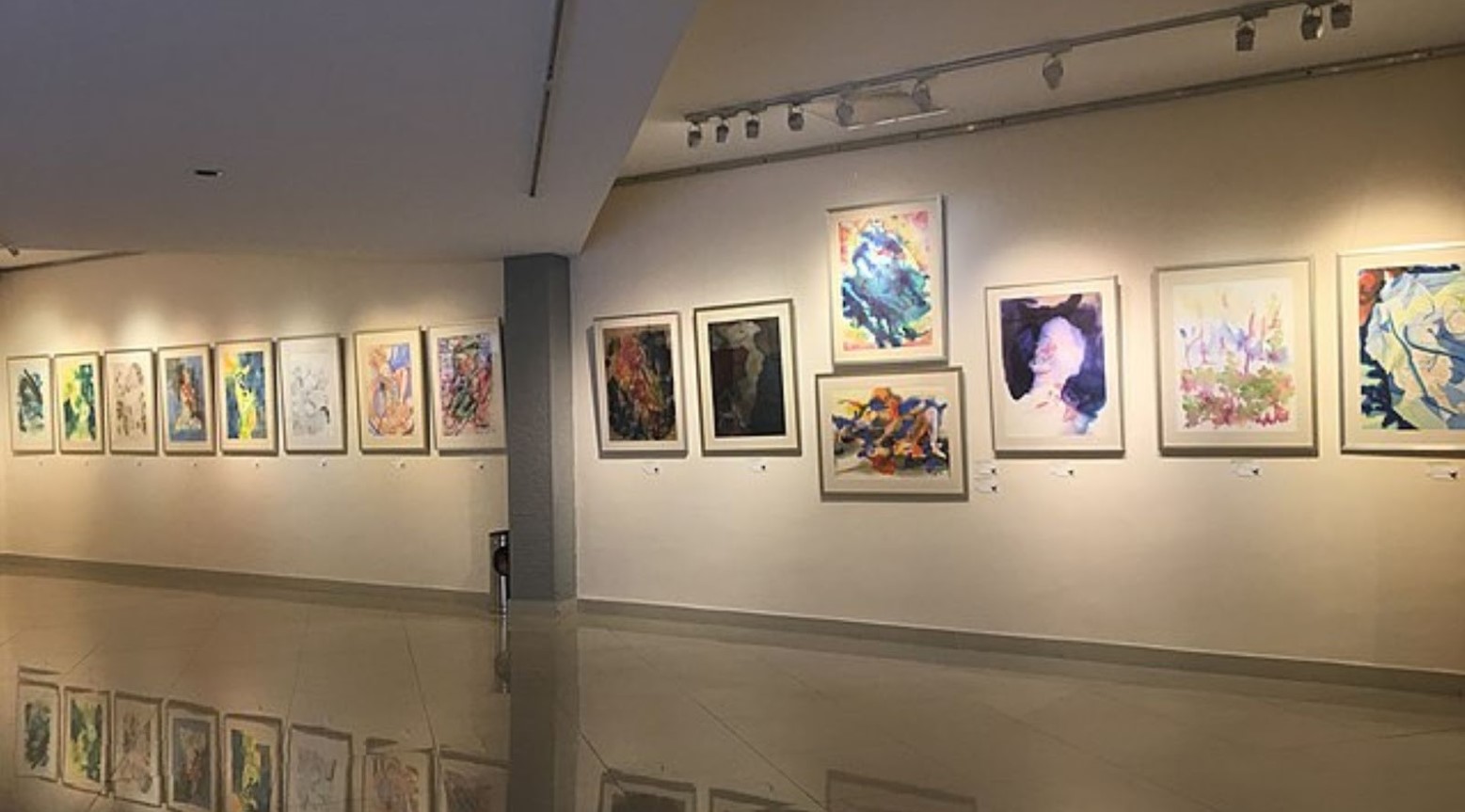 An art exhibition with various paintings and drawings on display.