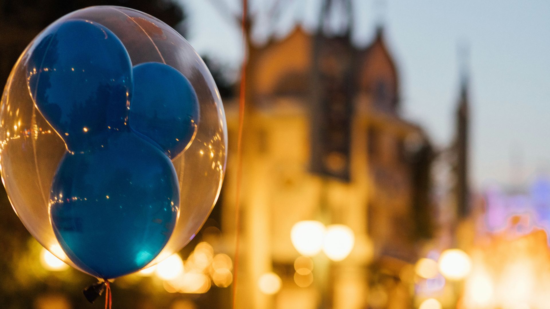 A close-up of a blue and white Mickey Mouse balloon at Disneyland.