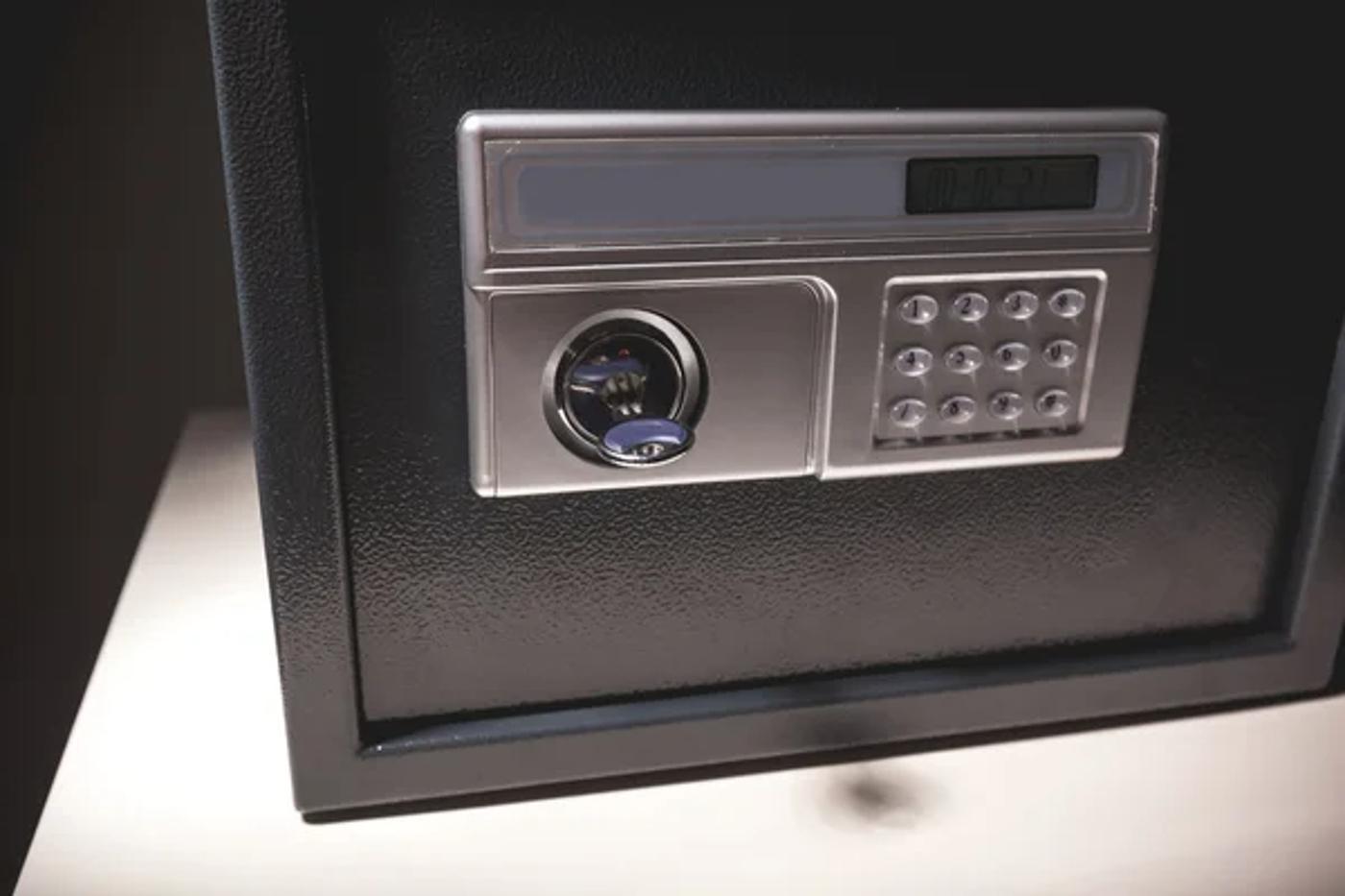 Close-up photograph of a safe with the key in the lock