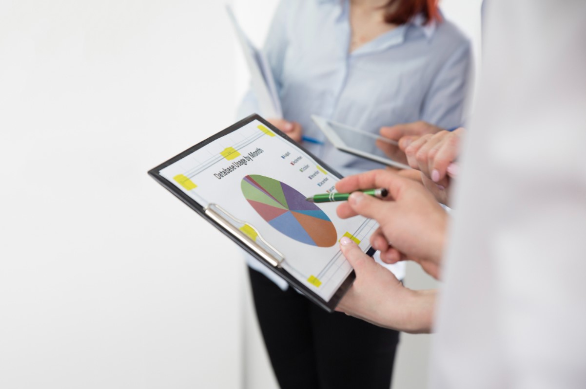 A man pictured with an iPad looks over data