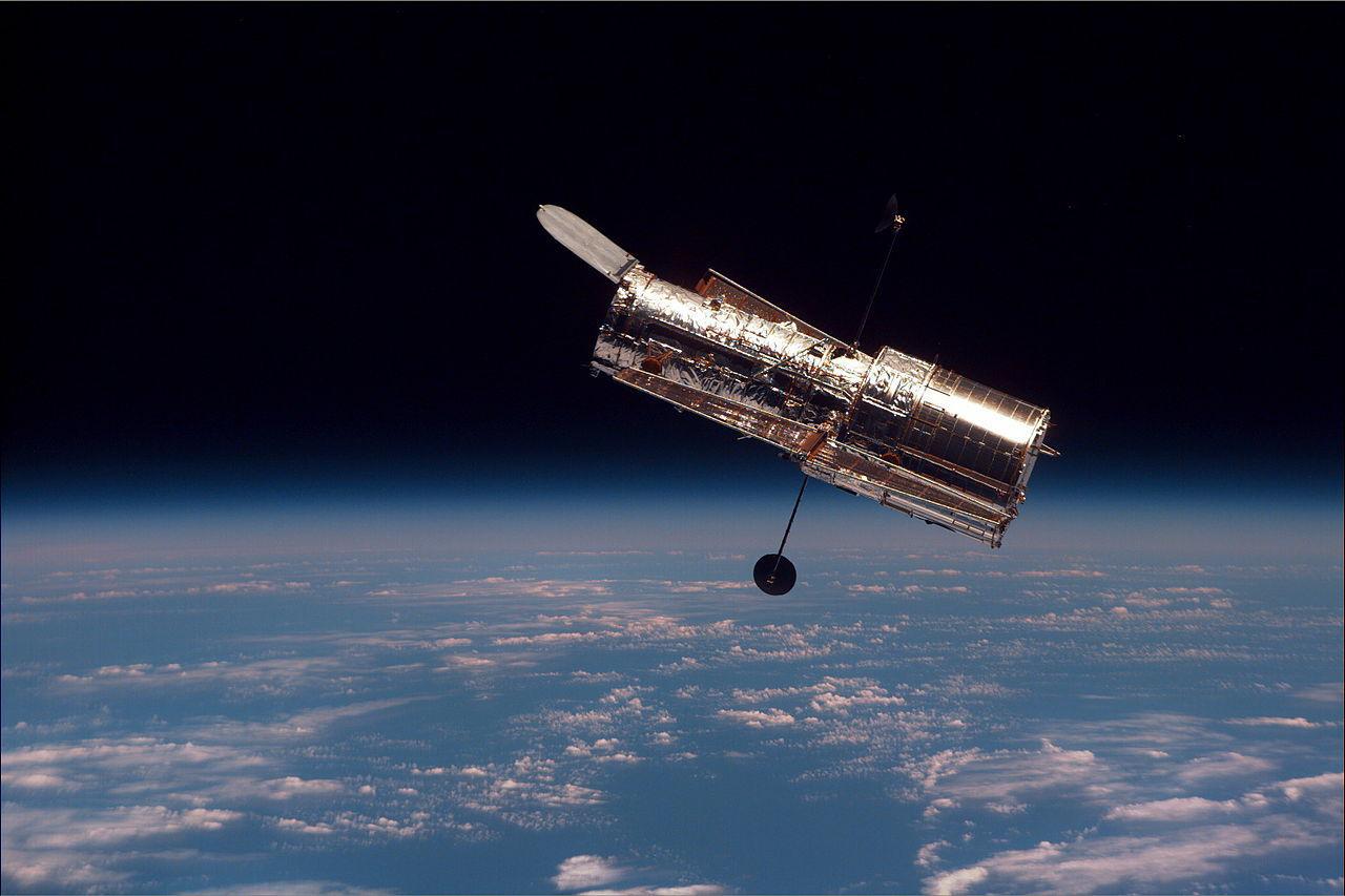 A photograph of the Hubble Telescope floating in space