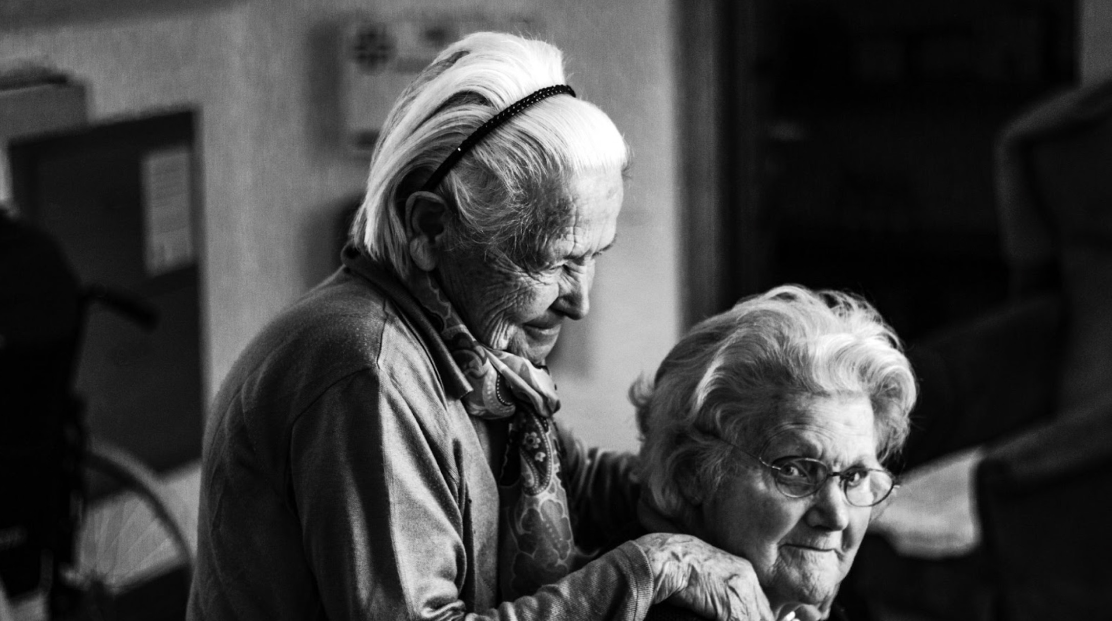 A black and white photo of two elderly friends.