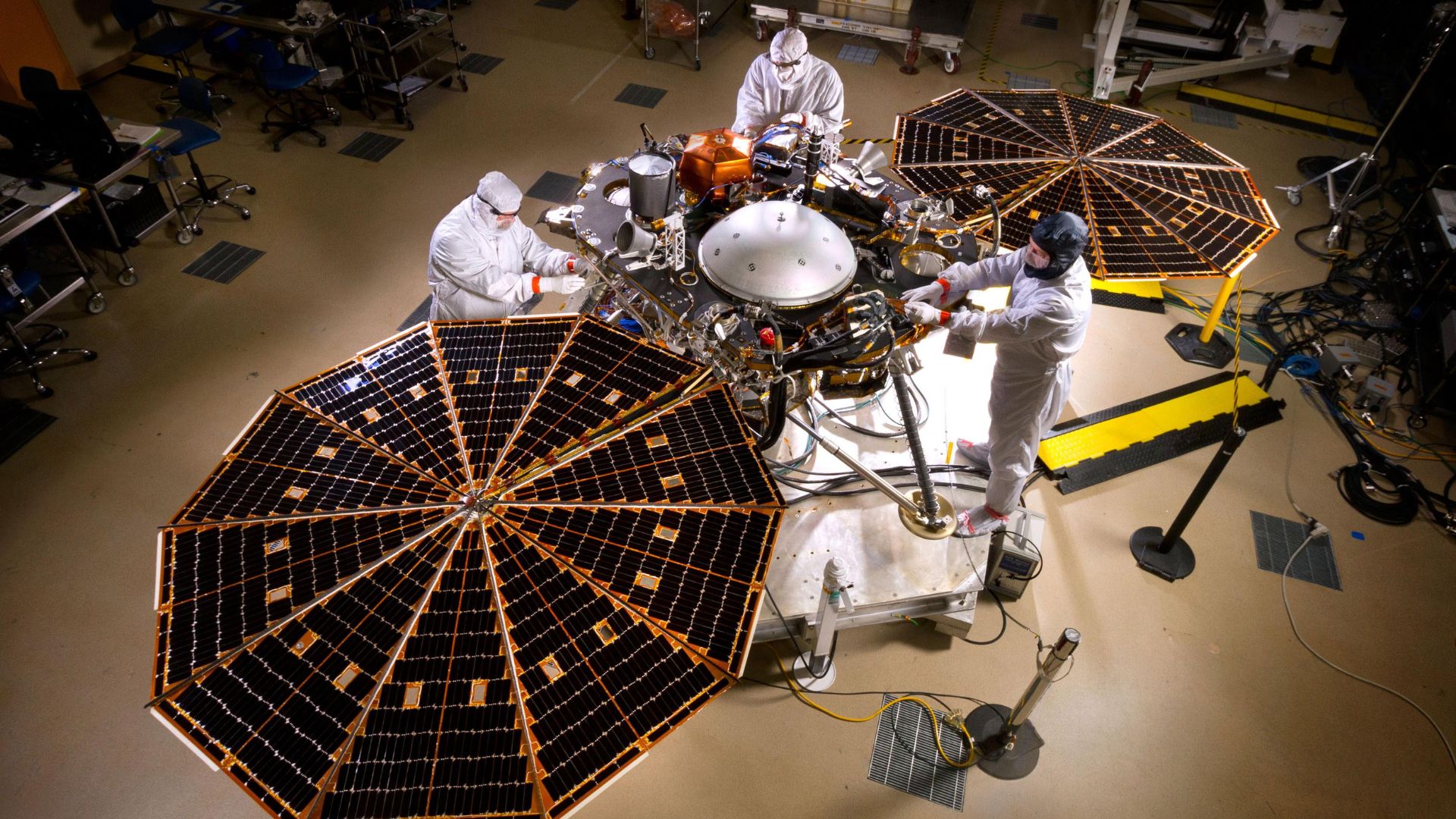 Scientists putting together the InSight lander in a facility.