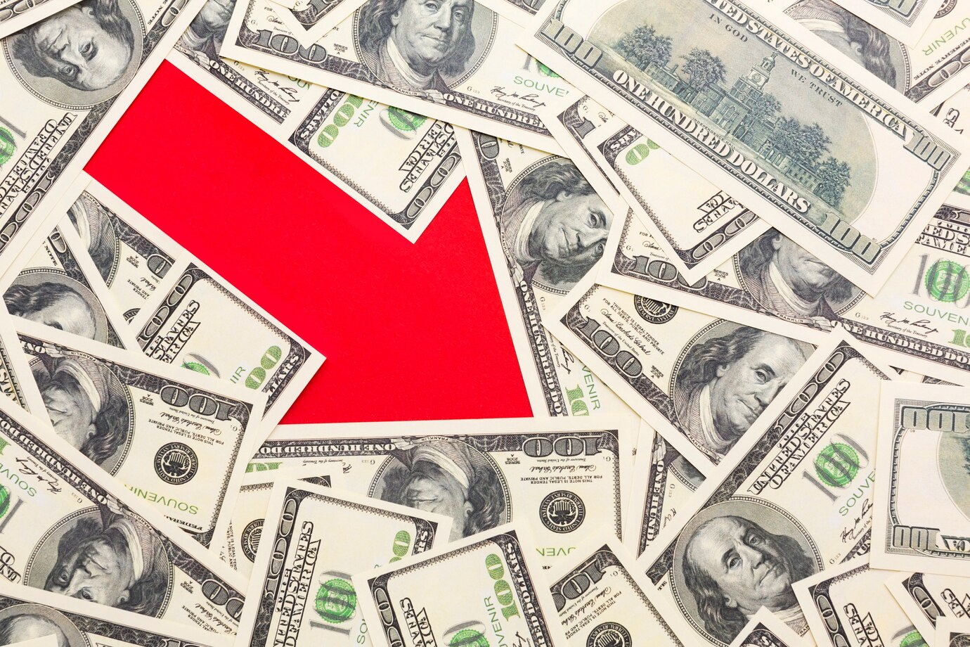 $100 bills with red downward arrow