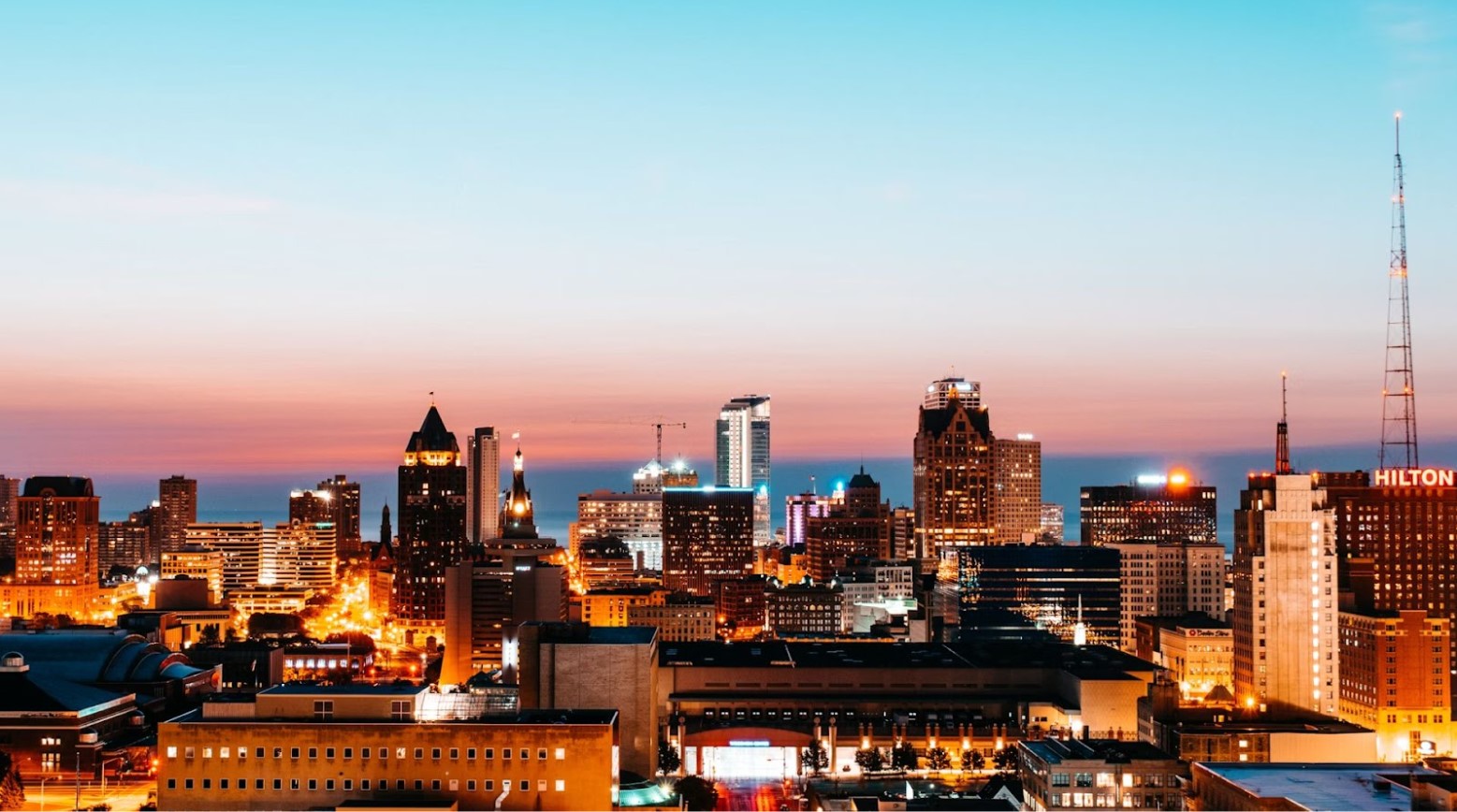 Milwaukee, Wisconsin, at sunset. The city has a lot of high-rise buildings.