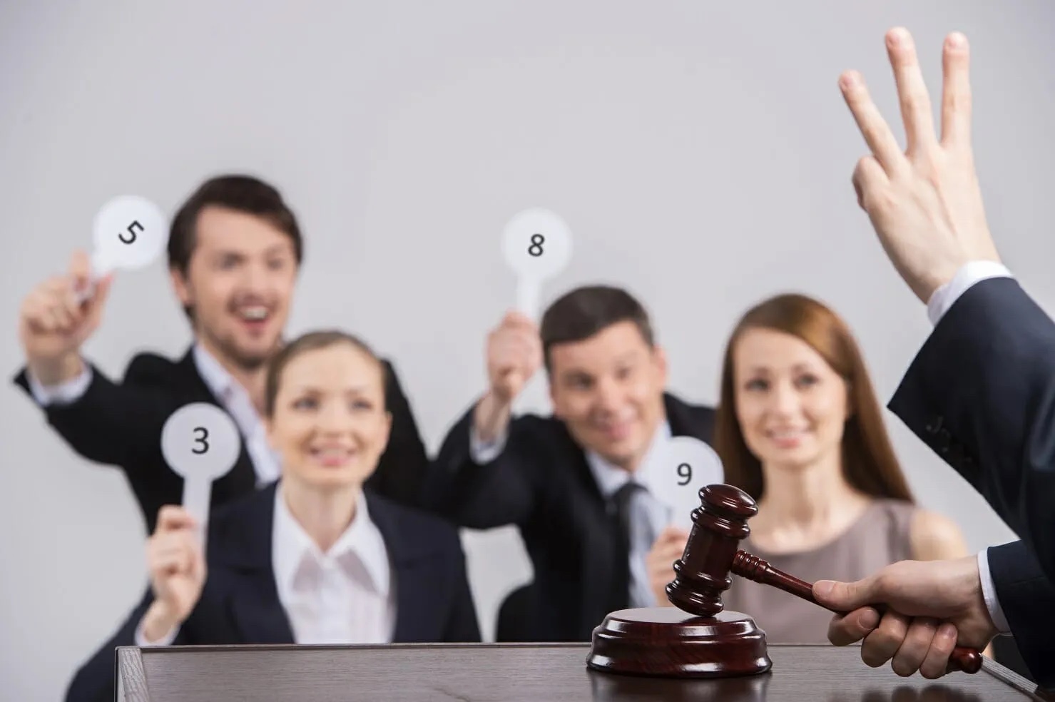 A group of people in suits at an auction