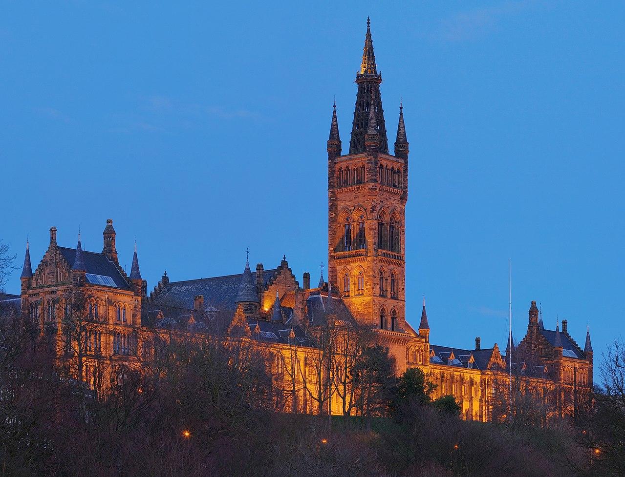 A photograph of Glasgow University's main building during twilight