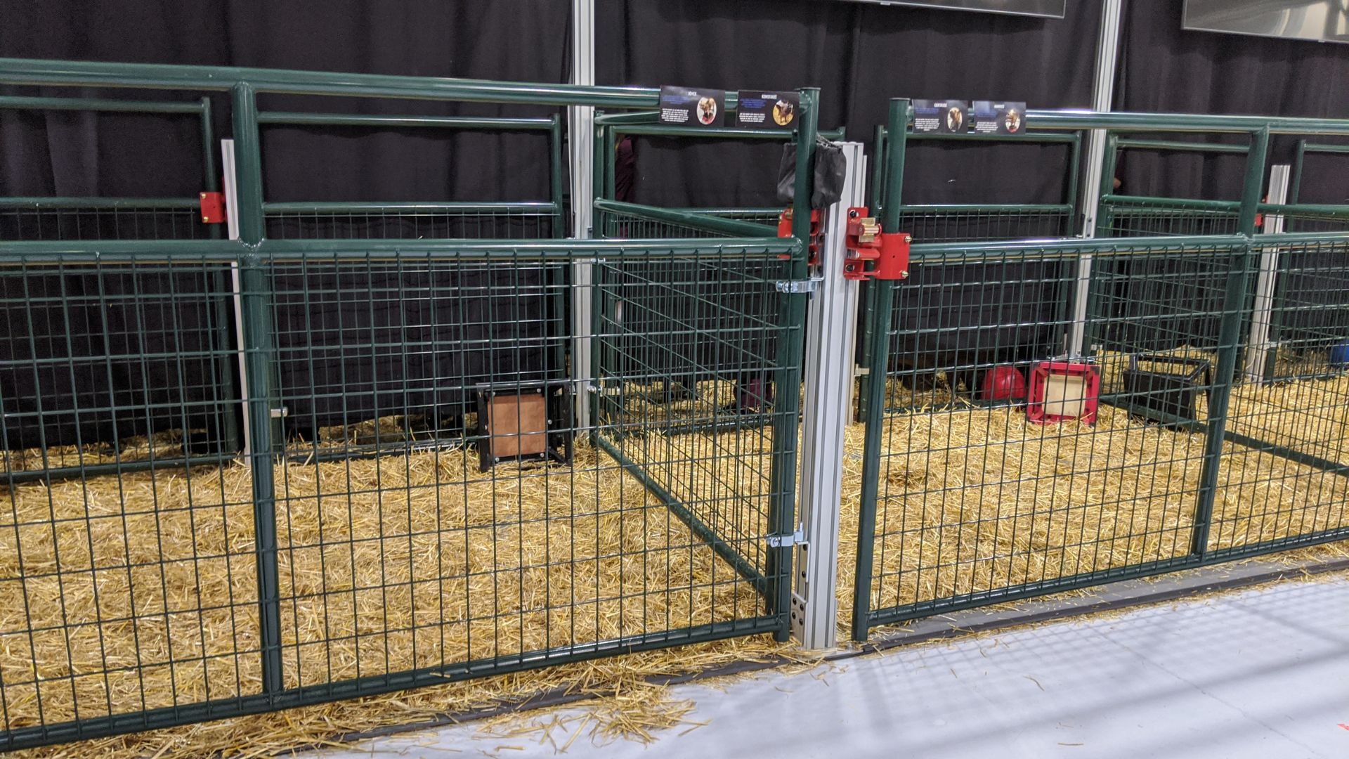 Two empty pig pens at a Neuralink facility.