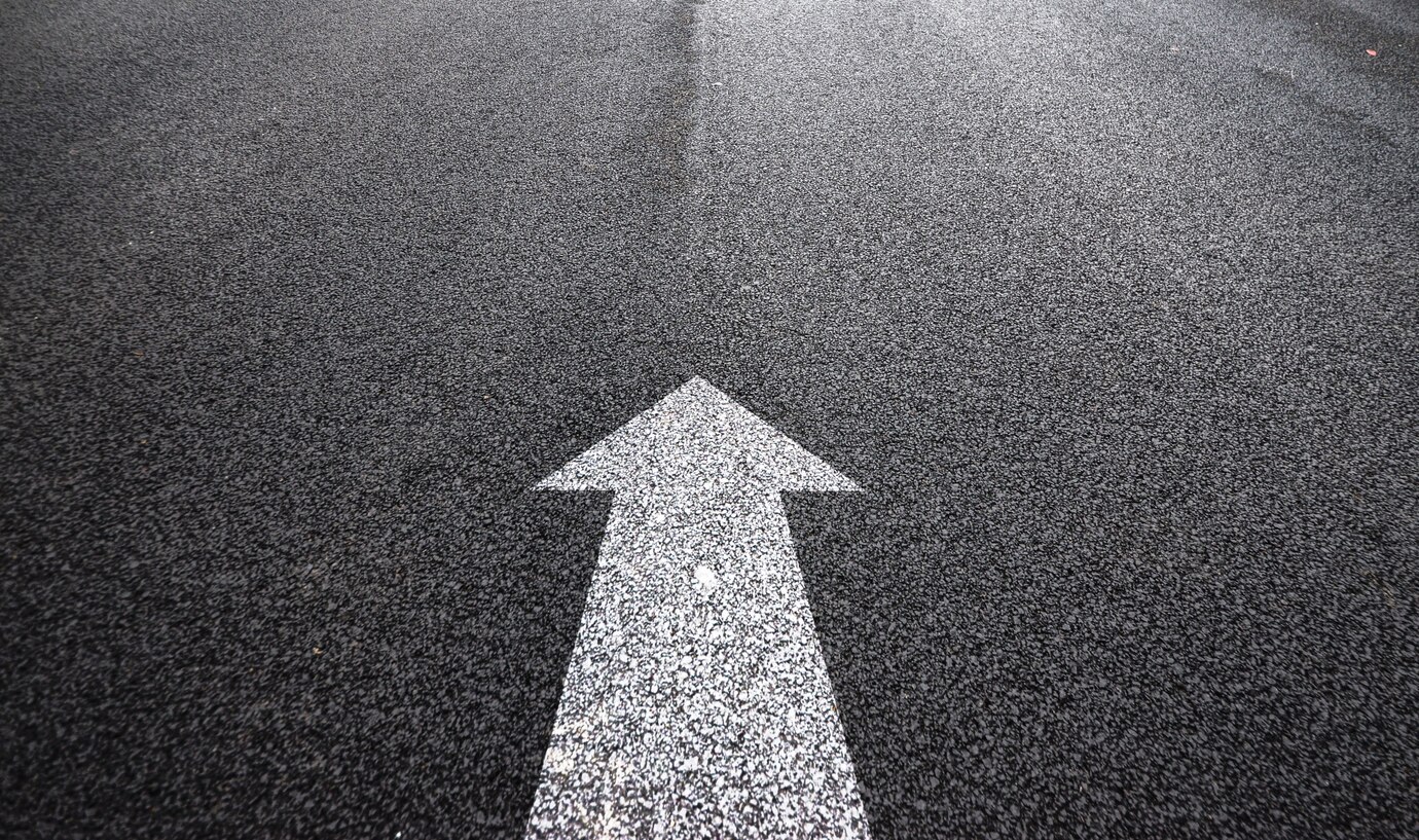 Upward pointing arrow on road