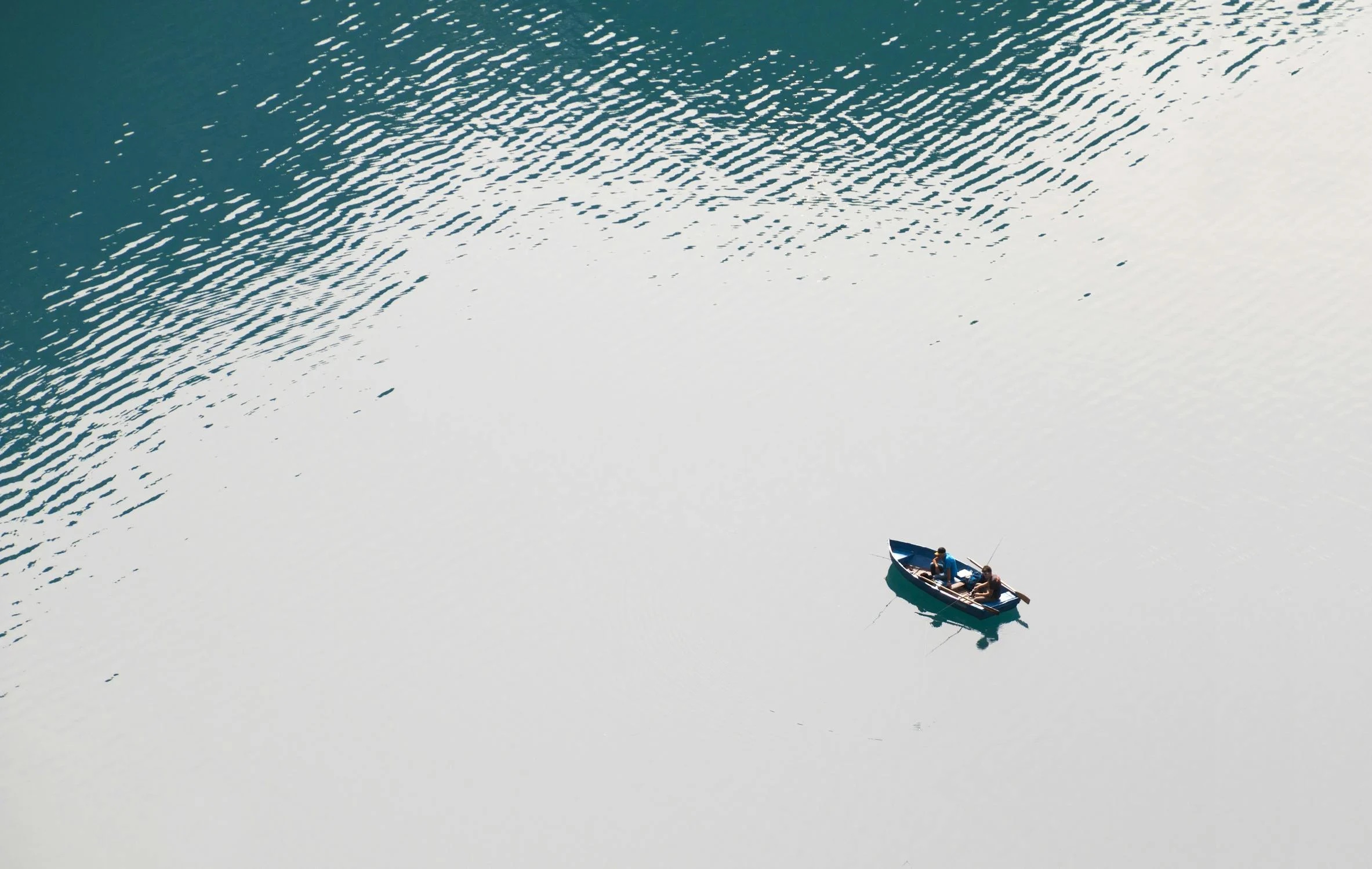A boat in the middle of a still lake