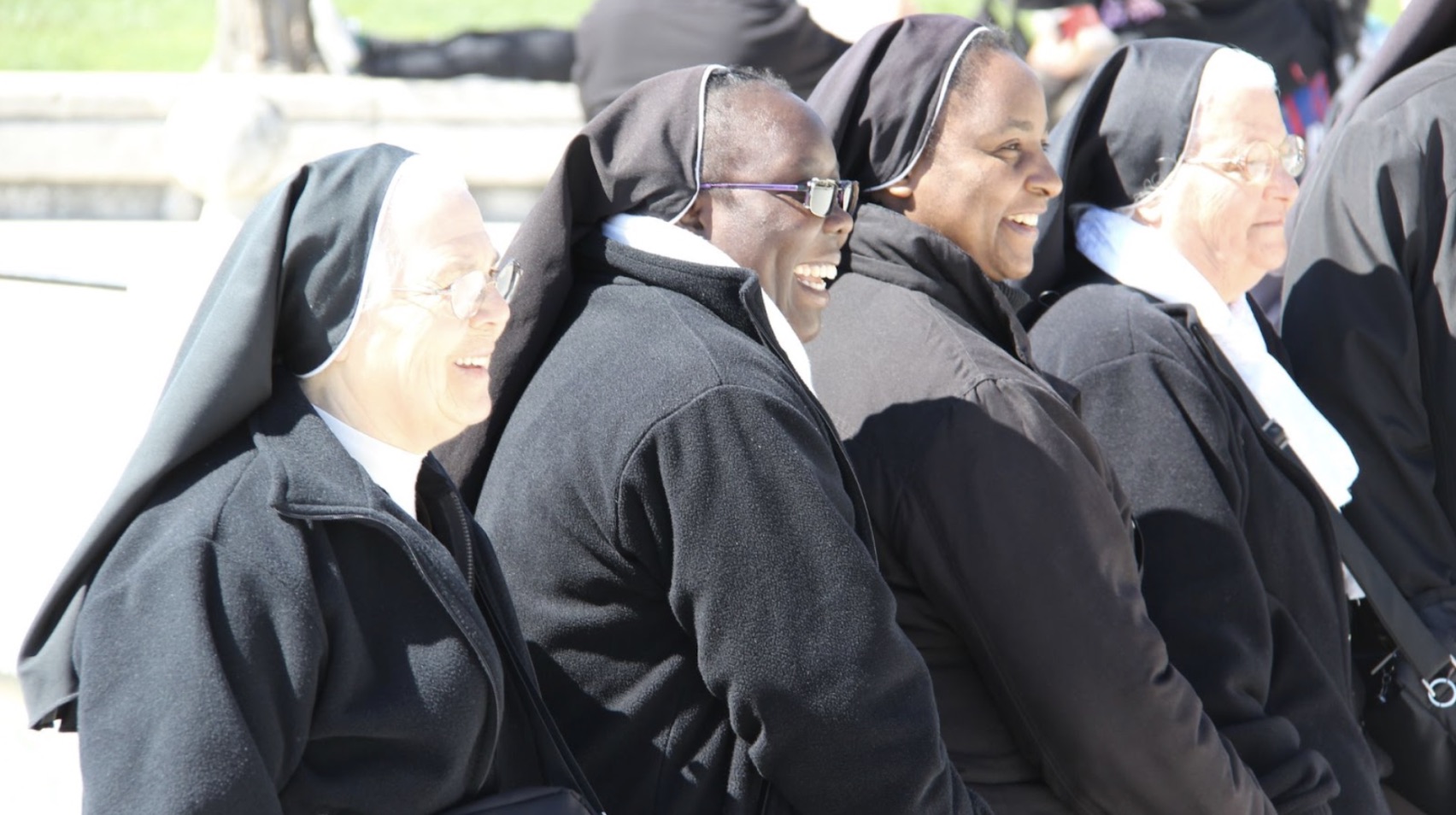 A group of smiling nuns in Padova, Italy in the daytime.