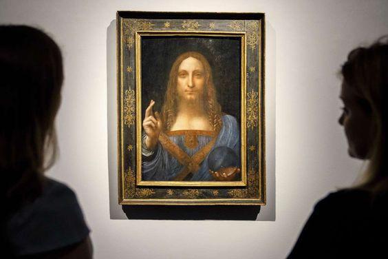 People viewing Salvator Mundi (Leonardo) framed.