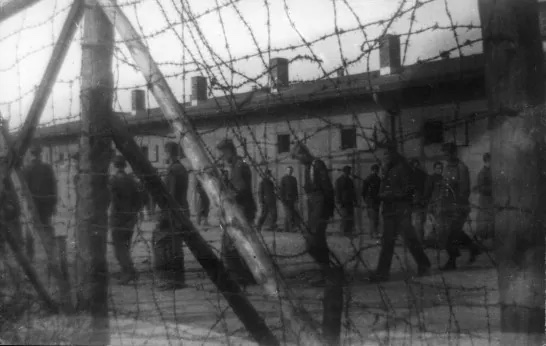 A black and white image of men in a POW camp