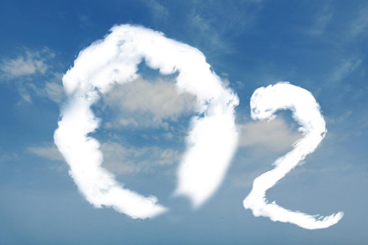 Photograph of a blue sky with the text “O2” written in clouds