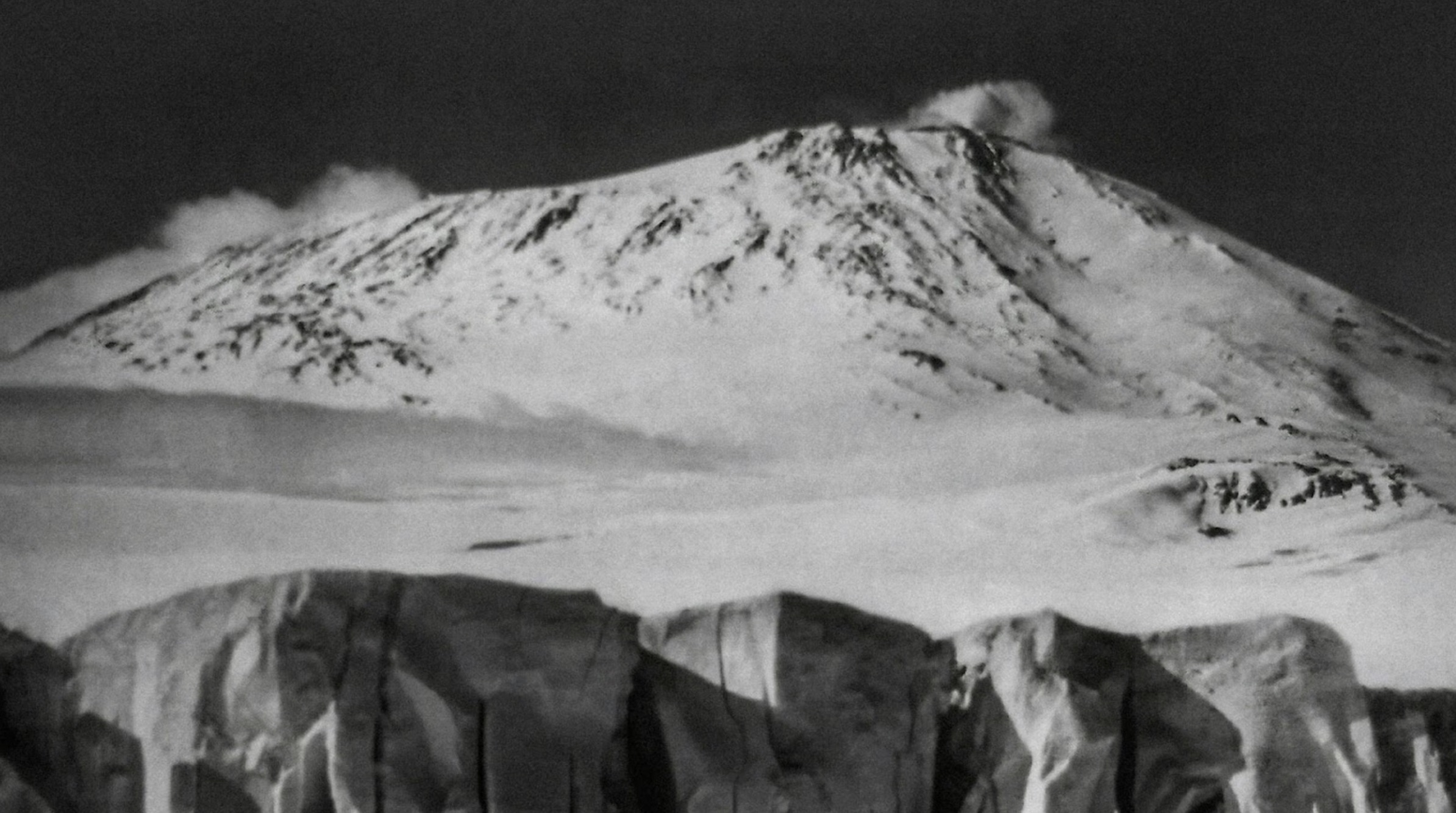 A black and white photo from 1911 of Mount Erebus.